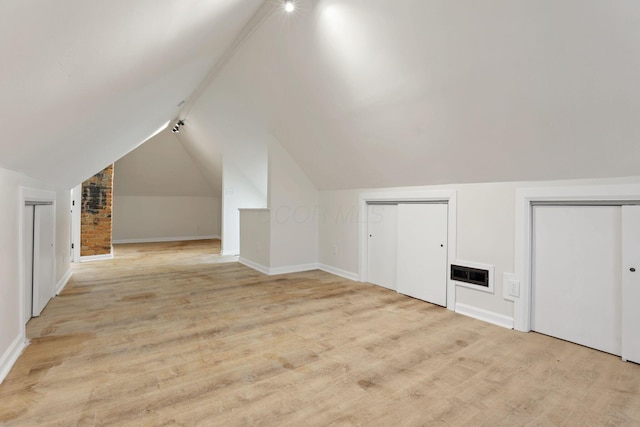 additional living space with light carpet and lofted ceiling