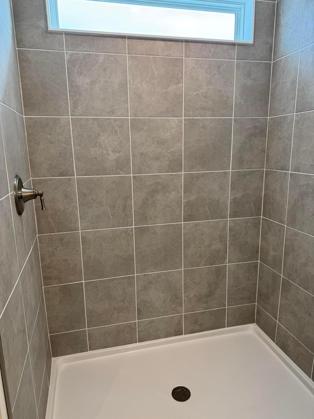 bathroom with a tile shower