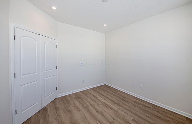 unfurnished bedroom featuring a closet and light hardwood / wood-style floors