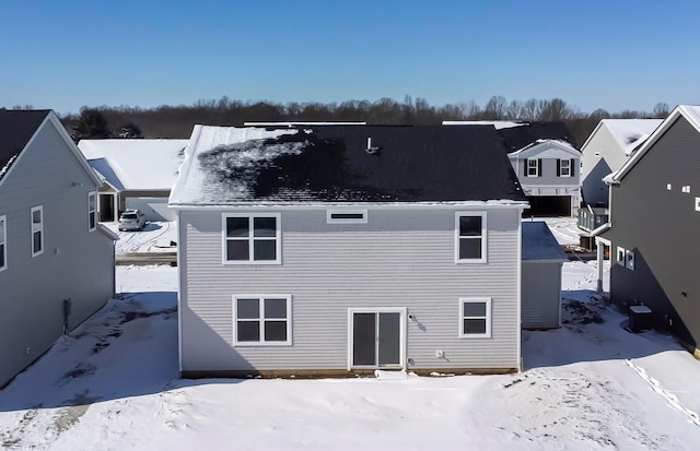 view of snow covered back of property