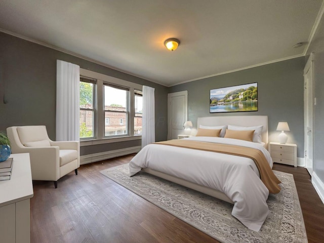 bedroom featuring hardwood / wood-style flooring, baseboard heating, and crown molding