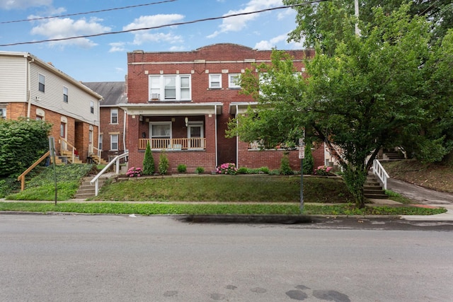 341 E 18th Ave, Columbus, OH 43201 - view of front of home with stairway, brick siding, covered porch, and a front yard