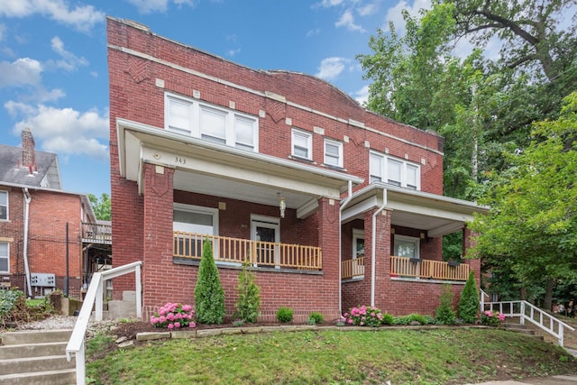 341 E 18th Ave, Columbus, OH 43201 - view of front of home featuring brick siding, a porch, and a front yard