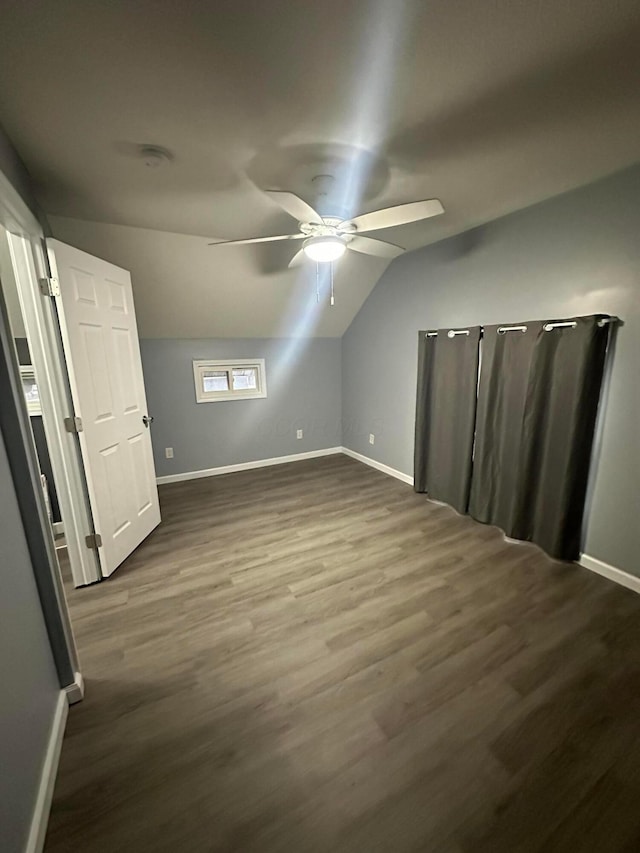 additional living space with ceiling fan, dark hardwood / wood-style flooring, and lofted ceiling