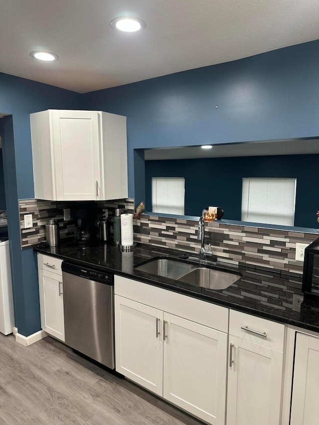 kitchen with dishwasher, white cabinets, light hardwood / wood-style floors, and sink