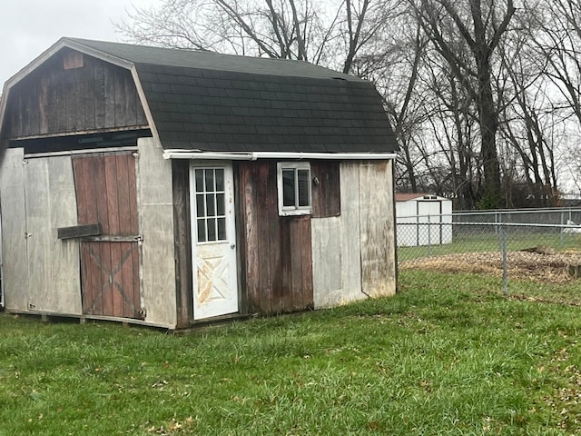 view of outbuilding featuring a yard