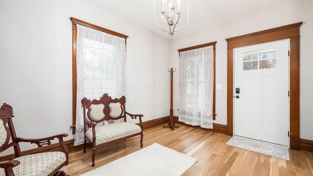 foyer with light hardwood / wood-style floors and an inviting chandelier