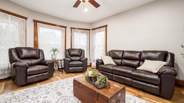 living room with ceiling fan and light wood-type flooring