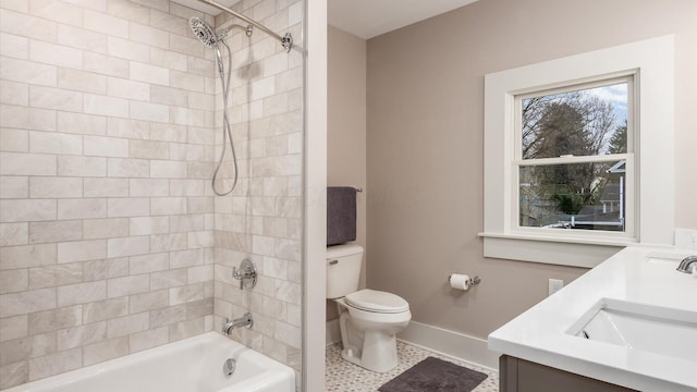 full bathroom featuring tile patterned flooring, vanity, toilet, and tiled shower / bath combo