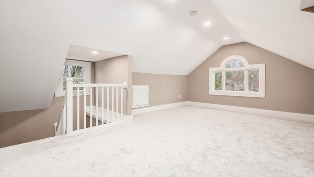 additional living space with plenty of natural light, carpet floors, and vaulted ceiling