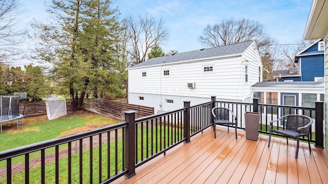 deck with a yard and a trampoline