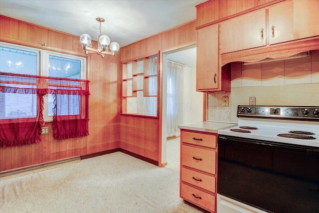 kitchen with wood walls, light carpet, an inviting chandelier, hanging light fixtures, and white electric range oven