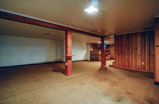 basement featuring wooden walls