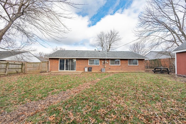 rear view of property with a yard