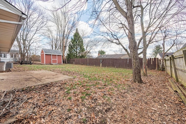 view of yard featuring a shed, cooling unit, and a patio area