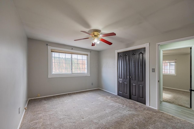 unfurnished bedroom featuring ceiling fan, carpet floors, and a closet