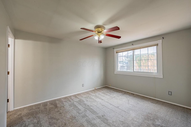 empty room with ceiling fan and carpet floors