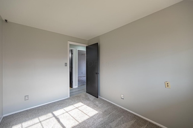 unfurnished room with light carpet