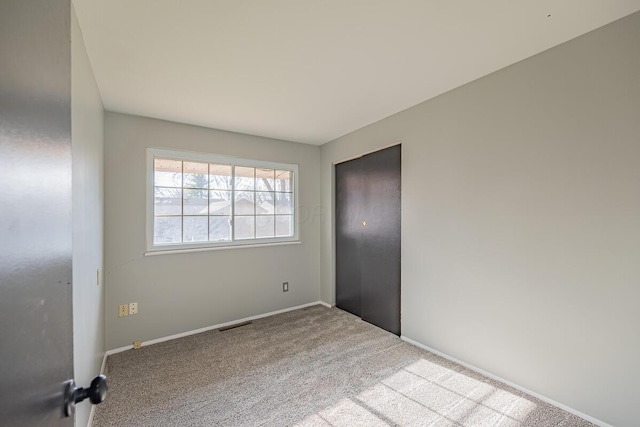 unfurnished room with light colored carpet