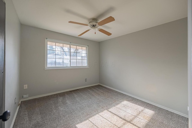 empty room featuring carpet flooring and ceiling fan