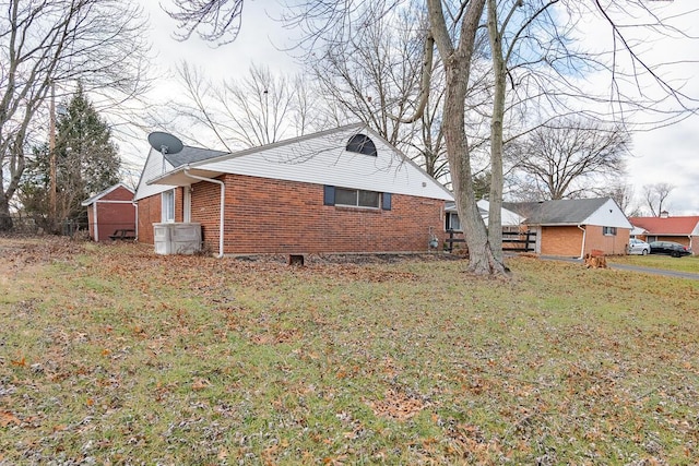 view of side of home with a yard