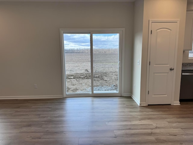 unfurnished room featuring wood finished floors and baseboards