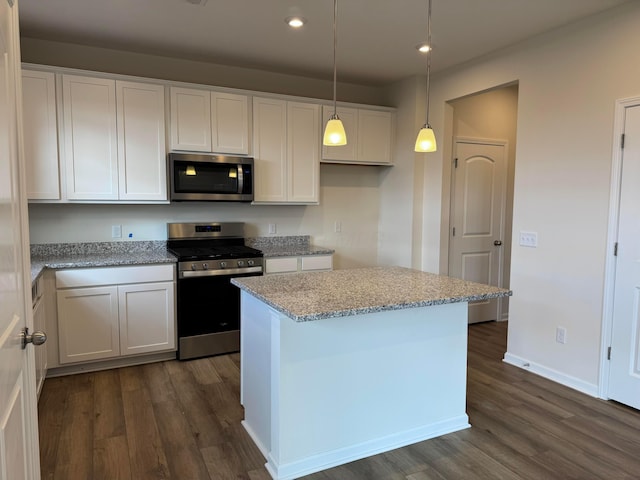 kitchen featuring stainless steel appliances, white cabinetry, and dark wood-style floors