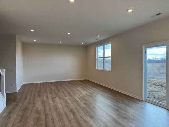 unfurnished room featuring recessed lighting, visible vents, and wood finished floors