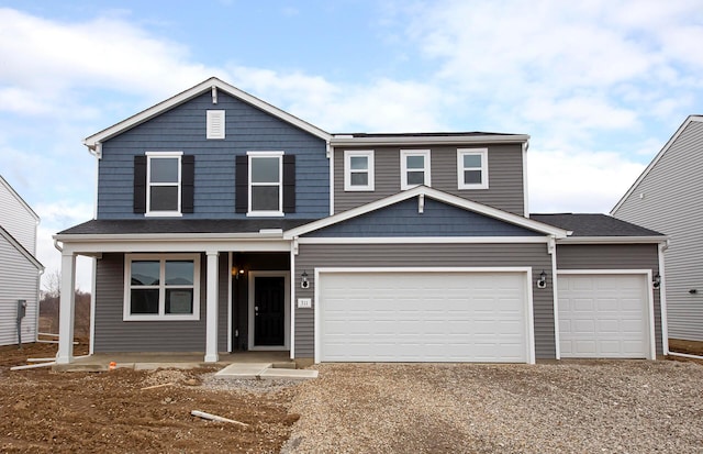 view of front of home with covered porch, driveway, and an attached garage