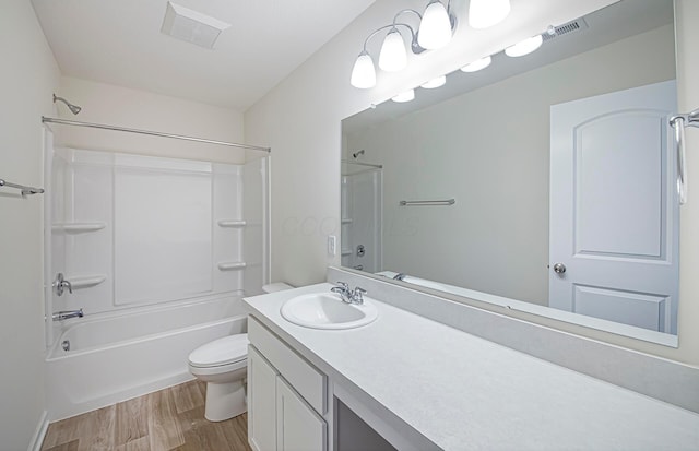 bathroom with toilet, visible vents, shower / washtub combination, and wood finished floors