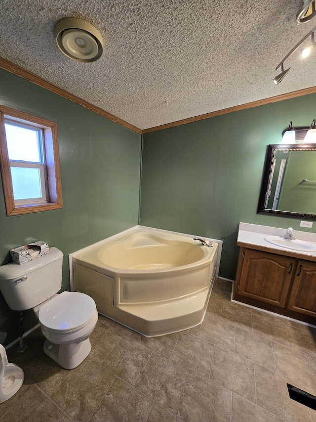 bathroom with a bathtub, vanity, a textured ceiling, crown molding, and toilet