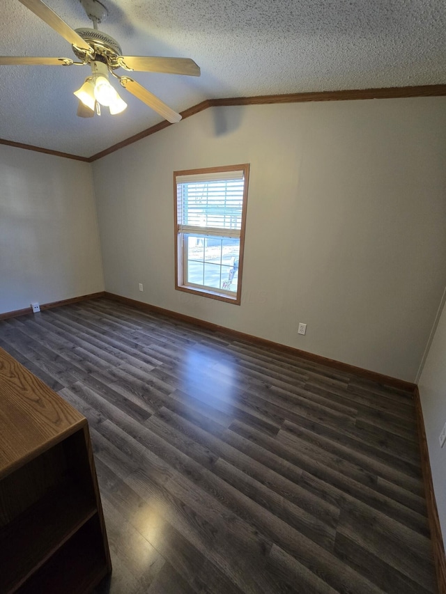 unfurnished room featuring ceiling fan, dark hardwood / wood-style floors, a textured ceiling, vaulted ceiling, and ornamental molding