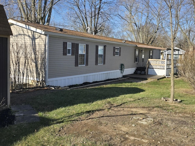 rear view of house with a yard