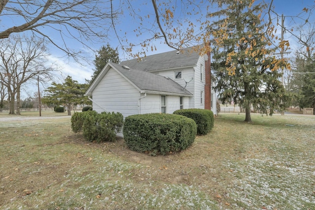 view of side of property featuring a lawn