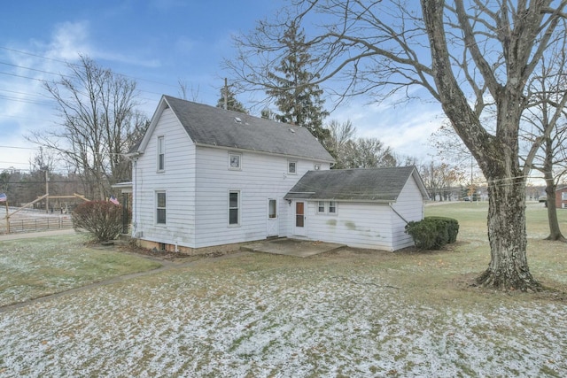 rear view of property featuring a lawn