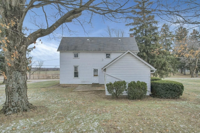 back of house featuring a patio and a lawn