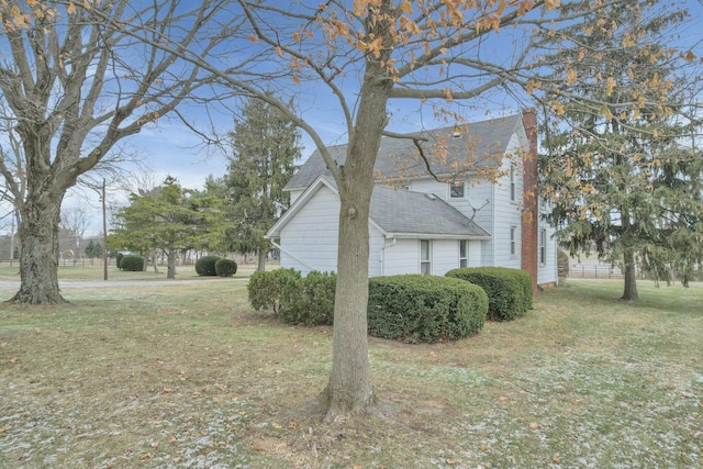 view of home's exterior with a lawn