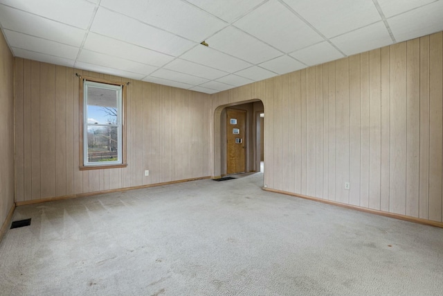 carpeted spare room featuring a paneled ceiling