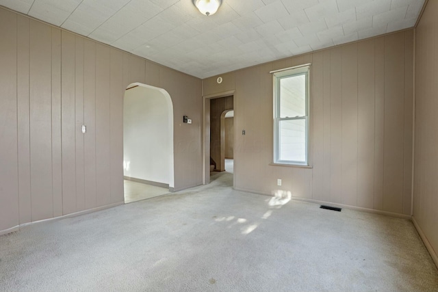 unfurnished room featuring light colored carpet