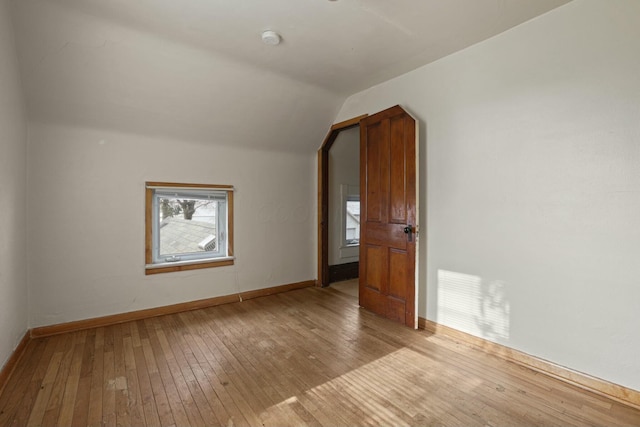 bonus room with light hardwood / wood-style flooring and lofted ceiling