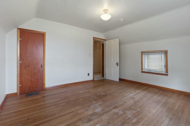 bonus room with wood-type flooring and lofted ceiling