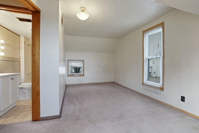 bonus room featuring light colored carpet and lofted ceiling