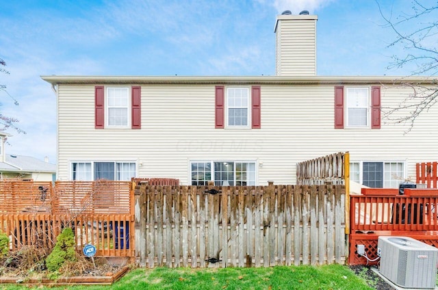 rear view of house featuring central AC