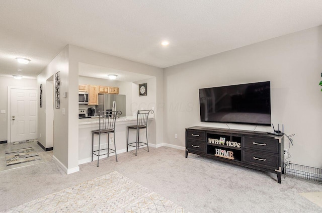 living room with light colored carpet and a textured ceiling