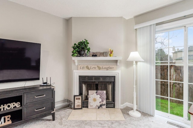 living room featuring light colored carpet and a textured ceiling