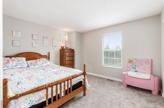 carpeted bedroom featuring a textured ceiling