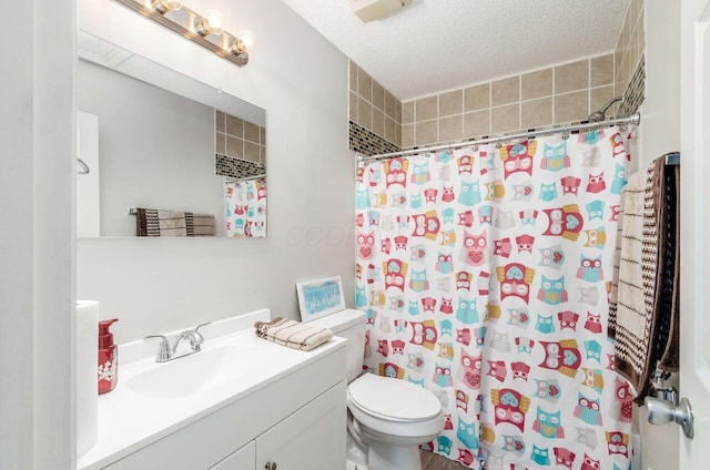 bathroom with vanity, a textured ceiling, toilet, and curtained shower