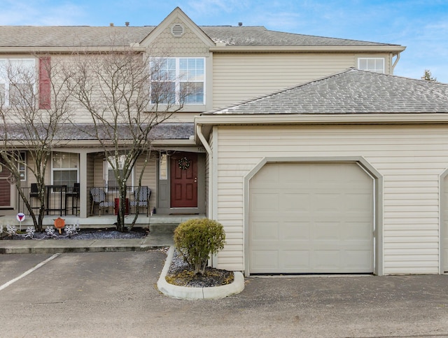 view of front of home with covered porch and a garage