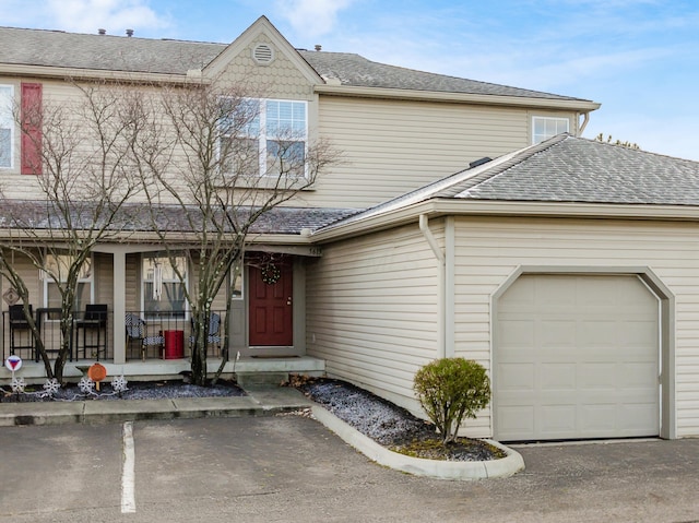 view of front of home with covered porch and a garage