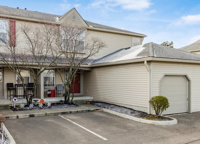 view of front of home with covered porch and a garage